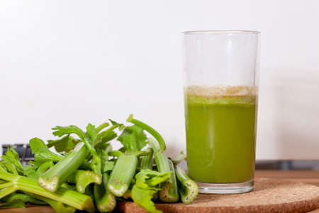 Healthy Celery diet for the treatment of incurable mysterious diseases. Fresh celery juice squeezed out on a juicer.drink, vegetable juice, studio shotの写真素材