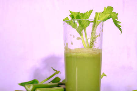 Healthy Celery diet for the treatment of incurable mysterious diseases. Fresh celery juice squeezed out on a juicer.drink, vegetable juice, studio shotの写真素材