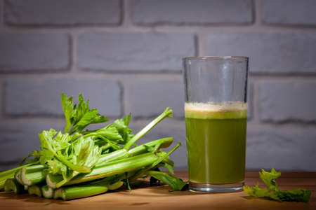 Healthy Celery diet for the treatment of incurable mysterious diseases. Fresh celery juice squeezed out on a juicer.drink, vegetable juice, studio shotの写真素材
