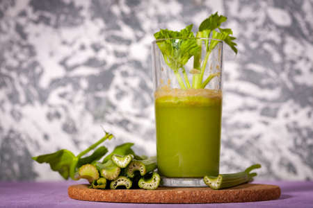 Healthy Celery diet for the treatment of incurable mysterious diseases. Fresh celery juice squeezed out on a juicer.drink, vegetable juice, studio shotの写真素材