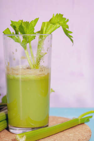 Healthy Celery diet for the treatment of incurable mysterious diseases. Fresh celery juice squeezed out on a juicer.drink, vegetable juice, studio shotの写真素材