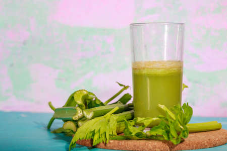 Healthy Celery diet for the treatment of incurable mysterious diseases. Fresh celery juice squeezed out on a juicer.drink, vegetable juice, studio shotの写真素材