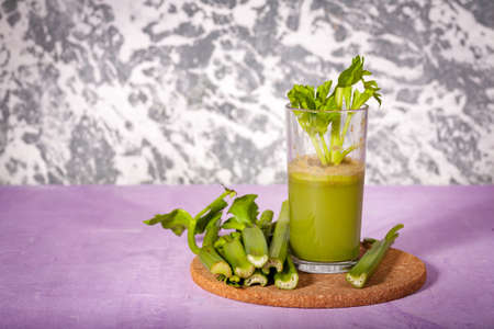 Healthy Celery diet for the treatment of incurable mysterious diseases. Fresh celery juice squeezed out on a juicer.drink, vegetable juice, studio shotの写真素材