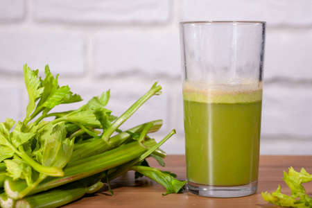 Healthy Celery diet for the treatment of incurable mysterious diseases. Fresh celery juice squeezed out on a juicer.drink, vegetable juice, studio shotの写真素材