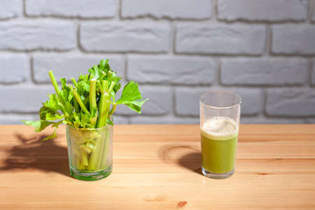 Healthy Celery diet for the treatment of incurable mysterious diseases. Fresh celery juice squeezed out on a juicer.drink, vegetable juice, studio shotの写真素材
