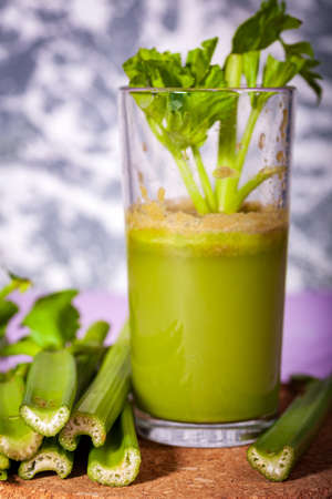 Healthy Celery diet for the treatment of incurable mysterious diseases. Fresh celery juice squeezed out on a juicer.drink, vegetable juice, studio shotの写真素材