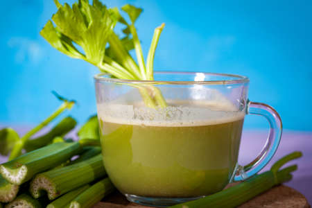 Healthy Celery diet for the treatment of incurable mysterious diseases. Fresh celery juice squeezed out on a juicer.drink, vegetable juice, studio shotの写真素材