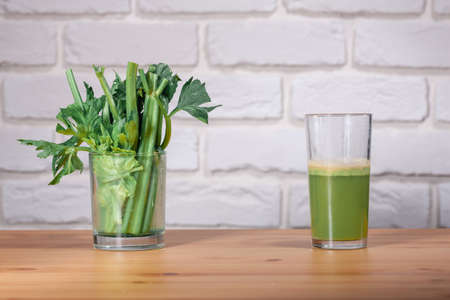 Healthy Celery diet for the treatment of incurable mysterious diseases. Fresh celery juice squeezed out on a juicer.drink, vegetable juice, studio shotの写真素材