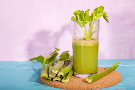 Healthy Celery diet for the treatment of incurable mysterious diseases. Fresh celery juice squeezed out on a juicer.drink, vegetable juice, studio shotの写真素材