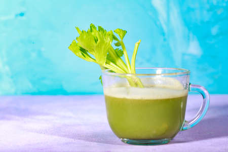 Healthy Celery diet for the treatment of incurable mysterious diseases. Fresh celery juice squeezed out on a juicer.drink, vegetable juice, studio shotの写真素材