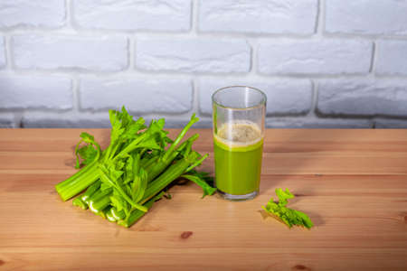 Healthy Celery diet for the treatment of incurable mysterious diseases. Fresh celery juice squeezed out on a juicer.drink, vegetable juice, studio shotの写真素材