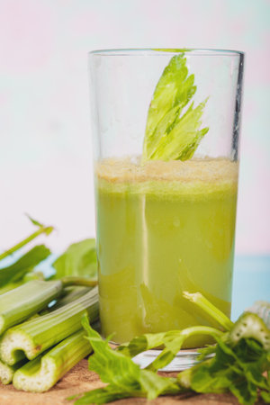 Healthy Celery diet for the treatment of incurable mysterious diseases. Fresh celery juice squeezed out on a juicer.drink, vegetable juice, studio shotの写真素材