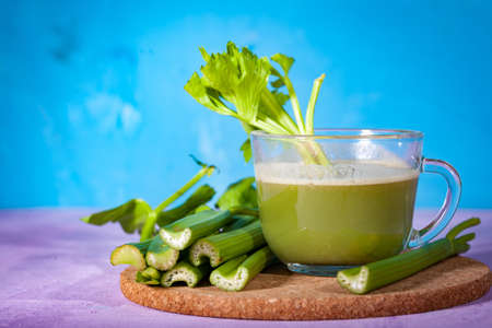 Healthy Celery diet for the treatment of incurable mysterious diseases. Fresh celery juice squeezed out on a juicer.drink, vegetable juice, studio shotの写真素材