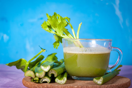 Healthy Celery diet for the treatment of incurable mysterious diseases. Fresh celery juice squeezed out on a juicer.drink, vegetable juice, studio shotの写真素材