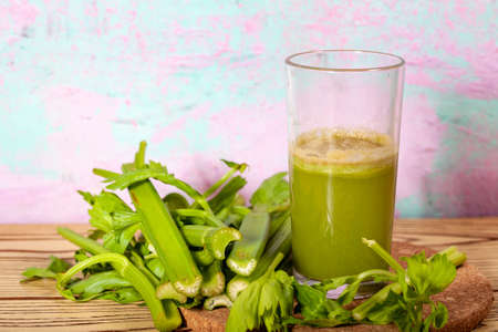 Healthy Celery diet for the treatment of incurable mysterious diseases. Fresh celery juice squeezed out on a juicer.drink, vegetable juice, studio shotの写真素材