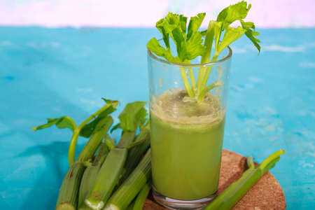 Healthy Celery diet for the treatment of incurable mysterious diseases. Fresh celery juice squeezed out on a juicer.drink, vegetable juice, studio shotの写真素材