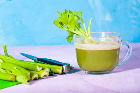 Healthy Celery diet for the treatment of incurable mysterious diseases. Fresh celery juice squeezed out on a juicer.drink, vegetable juice, studio shotの写真素材