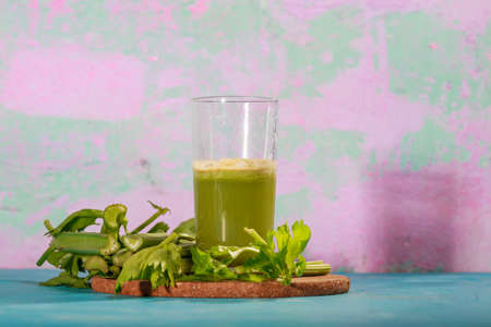 Healthy Celery diet for the treatment of incurable mysterious diseases. Fresh celery juice squeezed out on a juicer.drink, vegetable juice, studio shotの写真素材