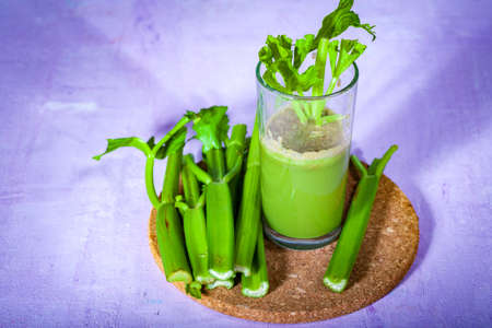 Healthy Celery diet for the treatment of incurable mysterious diseases. Fresh celery juice squeezed out on a juicer.drink, vegetable juice, studio shotの写真素材