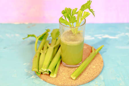 Healthy Celery diet for the treatment of incurable mysterious diseases. Fresh celery juice squeezed out on a juicer.drink, vegetable juice, studio shotの写真素材