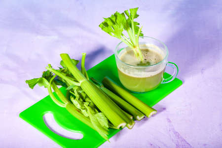 Healthy Celery diet for the treatment of incurable mysterious diseases. Fresh celery juice squeezed out on a juicer.drink, vegetable juice, studio shotの写真素材