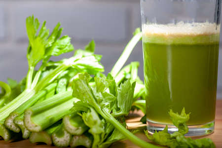 Healthy Celery diet for the treatment of incurable mysterious diseases. Fresh celery juice squeezed out on a juicer.drink, vegetable juice, studio shotの写真素材