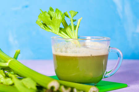Healthy Celery diet for the treatment of incurable mysterious diseases. Fresh celery juice squeezed out on a juicer.drink, vegetable juice, studio shotの写真素材