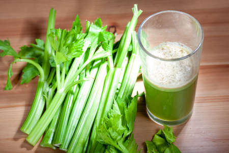 Healthy Celery diet for the treatment of incurable mysterious diseases. Fresh celery juice squeezed out on a juicer.drink, vegetable juice, studio shotの写真素材