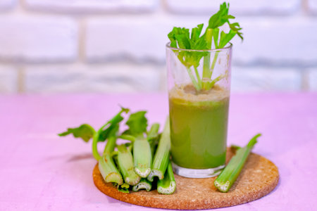 Healthy Celery diet for the treatment of incurable mysterious diseases. Fresh celery juice squeezed out on a juicer.drink, vegetable juice, studio shotの写真素材