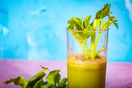 Healthy Celery diet for the treatment of incurable mysterious diseases. Fresh celery juice squeezed out on a juicer.drink, vegetable juice, studio shotの写真素材