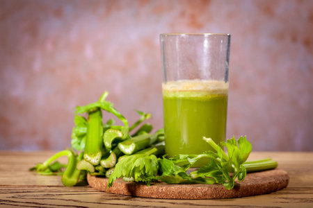 Healthy Celery diet for the treatment of incurable mysterious diseases. Fresh celery juice squeezed out on a juicer.drink, vegetable juice, studio shotの写真素材