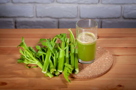 Healthy Celery diet for the treatment of incurable mysterious diseases. Fresh celery juice squeezed out on a juicer.drink, vegetable juice, studio shotの写真素材
