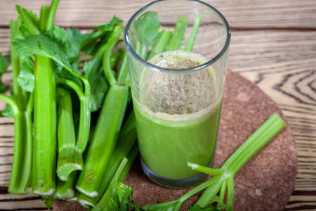 Healthy Celery diet for the treatment of incurable mysterious diseases. Fresh celery juice squeezed out on a juicer.drink, vegetable juice, studio shotの写真素材
