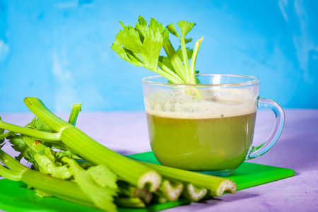 Healthy Celery diet for the treatment of incurable mysterious diseases. Fresh celery juice squeezed out on a juicer.drink, vegetable juice, studio shotの写真素材
