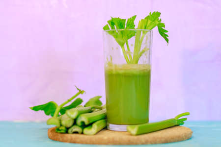Healthy Celery diet for the treatment of incurable mysterious diseases. Fresh celery juice squeezed out on a juicer.drink, vegetable juice, studio shotの写真素材