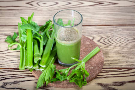 Healthy Celery diet for the treatment of incurable mysterious diseases. Fresh celery juice squeezed out on a juicer.drink, vegetable juice, studio shotの写真素材