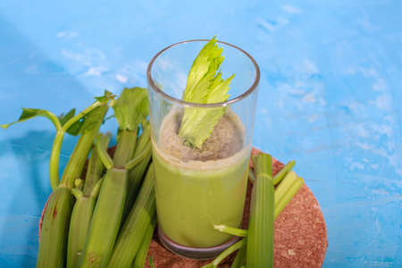 Healthy Celery diet for the treatment of incurable mysterious diseases. Fresh celery juice squeezed out on a juicer.drink, vegetable juice, studio shotの写真素材