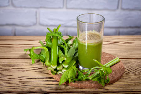 Healthy Celery diet for the treatment of incurable mysterious diseases. Fresh celery juice squeezed out on a juicer.drink, vegetable juice, studio shotの写真素材