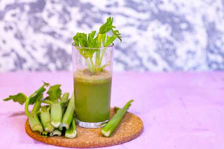 Healthy Celery diet for the treatment of incurable mysterious diseases. Fresh celery juice squeezed out on a juicer.drink, vegetable juice, studio shotの写真素材