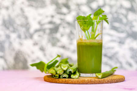 Healthy Celery diet for the treatment of incurable mysterious diseases. Fresh celery juice squeezed out on a juicer.drink, vegetable juice, studio shotの写真素材