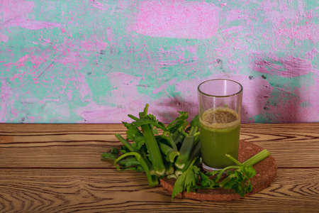 Healthy Celery diet for the treatment of incurable mysterious diseases. Fresh celery juice squeezed out on a juicer.drink, vegetable juice, studio shotの写真素材