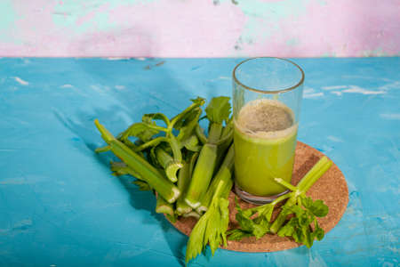Healthy Celery diet for the treatment of incurable mysterious diseases. Fresh celery juice squeezed out on a juicer.drink, vegetable juice, studio shotの写真素材