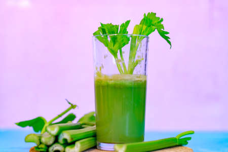 Healthy Celery diet for the treatment of incurable mysterious diseases. Fresh celery juice squeezed out on a juicer.drink, vegetable juice, studio shotの写真素材