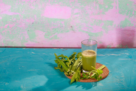 Healthy Celery diet for the treatment of incurable mysterious diseases. Fresh celery juice squeezed out on a juicer.drink, vegetable juice, studio shotの写真素材