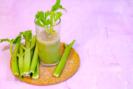 Healthy Celery diet for the treatment of incurable mysterious diseases. Fresh celery juice squeezed out on a juicer.drink, vegetable juice, studio shotの写真素材