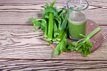 Healthy Celery diet for the treatment of incurable mysterious diseases. Fresh celery juice squeezed out on a juicer.drink, vegetable juice, studio shotの写真素材