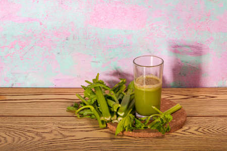 Healthy Celery diet for the treatment of incurable mysterious diseases. Fresh celery juice squeezed out on a juicer.drink, vegetable juice, studio shotの写真素材