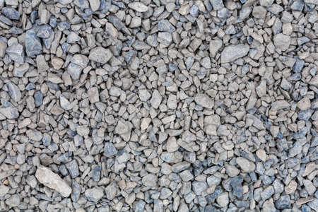 brick rubble debris on construction site. inorganic crushed stone, non-round, loose material with grains. Artificially obtained by crushing coarse-grained rocks and pebbles, accidentally mined overburden and enclosing rocks or substandard waste of mining enterprises for ore processing.の写真素材