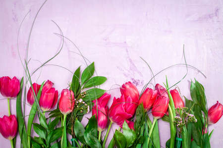 Row of red tulips on wooden background with space for message. Mothers Day background. Top viewの写真素材