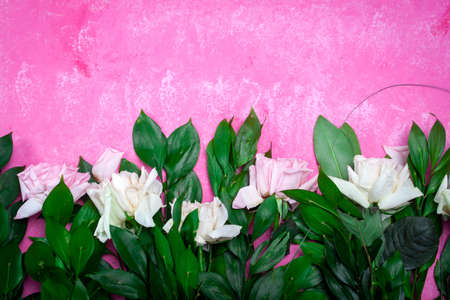 Small white flowers on a toned on gentle soft blue and pink background outdoors close-up macro . Spring summer border template floral background. Light air delicate artistic image, free space.の写真素材